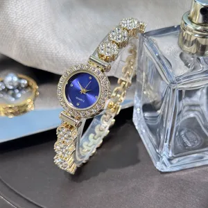 Women rhinestone quartz watch detail view, blue dial elegant alloy bracelet luxury timepiece.