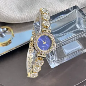 Close-up detail of women's rhinestone quartz watch with blue dial and sparkling crystal link strap.