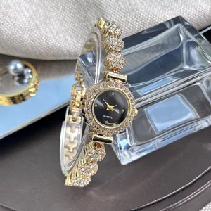 Detailed close-up view of women gold quartz watch featuring black dial and sparkling rhinestones.