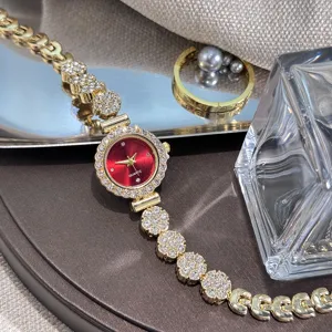 Elegant women's rhinestone quartz watch with red round dial and chic floral chain strap.