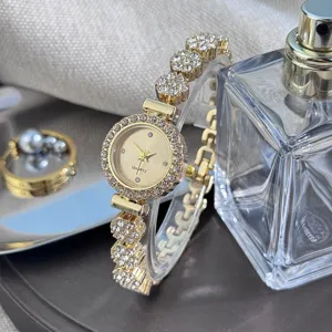 Detailed close-up of luxury gold rhinestone bracelet quartz watch for women elegant alloy.