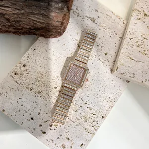 Detailed shot of a luxury square quartz women watch with full rhinestones on stone background.