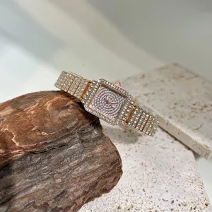 Stunning detailed shot of a square rhinestone women quartz watch sparkling with crystal details.