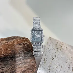Detail view of a stunning full diamond square women quartz watch with sparkling rhinestones.