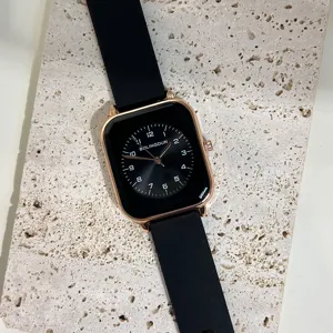 Minimalist square quartz watch with black silicone strap and clear digital dial for women.