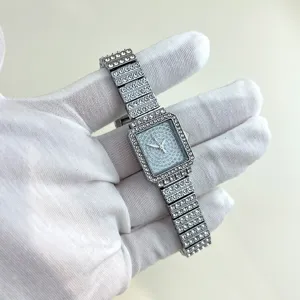 Detailed close-up of sparkling rhinestone square quartz watch with dazzling crystal pave band.