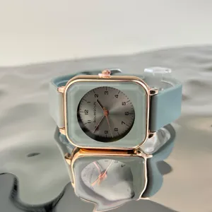 Close-up detail of the minimalist square quartz watch featuring mint green silicone strap.