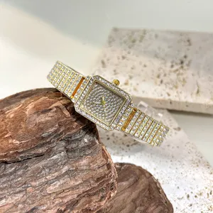 Luxury square rhinestone quartz watch detail showcasing sparkling crystals and gold bracelet band.