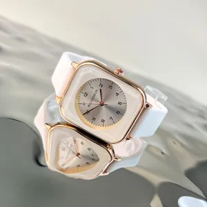 Close-up detail of the square quartz watch with white silicone strap and clear numeric dial.