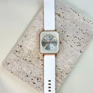 Minimalist women quartz watch with square rose gold case and comfortable white silicone strap.