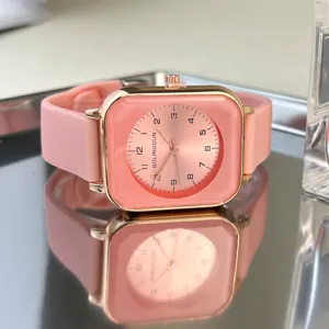 Pink square silicone strap quartz watch detail shot, minimalist design with clear digital dial.