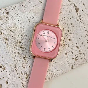 Detailed close-up shot of the pink square quartz watch dial and silky soft silicone strap.
