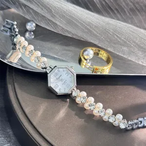 Nahaufnahme Detail der silbernen achteckigen Quarzuhr mit Perlen-Strass-Armband.