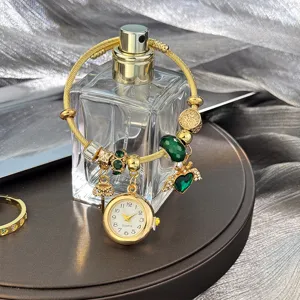 Gold charm bracelet with green beads, heart wing pendant and quartz watch for women stylish gift