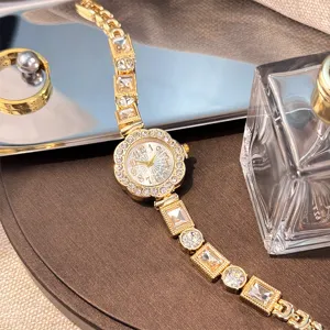 Close-up of luxury rhinestone flower bracelet quartz watch with sparkling crystal links.