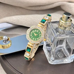 Close-up of women's quartz watch with green floral dial, sparkling rhinestones and gemstone bracelet.