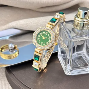 Luxury green gemstone quartz wristwatch with crystal rhinestones and gold metal bracelet.