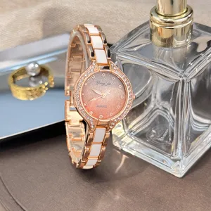 Detail view of women quartz watch with pink gradient glitter dial and ceramic bracelet.