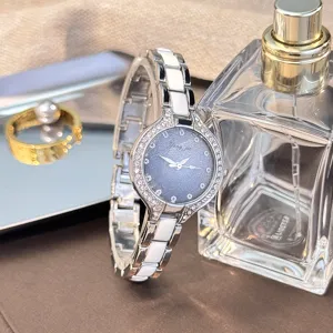 Detailed view of women quartz watch, sparkling starry rhinestones dial, ceramic strap.