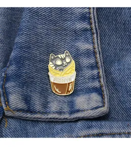 Cute cat burrito enamel pin detail closeup, alloy badge decoration for clothes, denim aesthetic.
