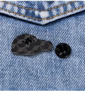 Detailed back view of creative brain enamel brooch pin with butterfly clutch on denim fabric.