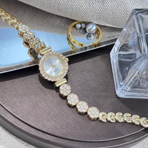 Detail shot of elegant rhinestone bracelet watch with sparkling crystal flowers and dial.