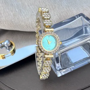 Rhinestone bracelet watch detail, sparkling crystal bezel, turquoise dial close-up view.