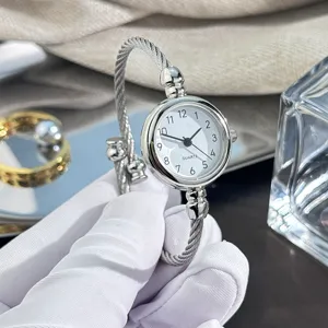 Detailansicht einer stilvollen silbernen Armreif-Quarzuhr, elegantes retro Damendesign.