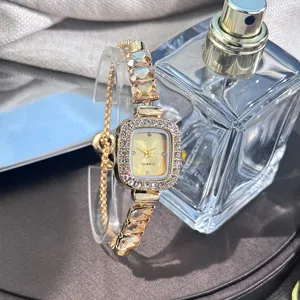 Detailed close-up of a glamorous gold quartz wristwatch featuring rhinestone bezel and crystals.