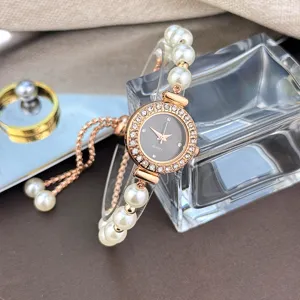 Elegant pearl strap quartz watch detail featuring sparkling rhinestones and a chic rose gold dial.