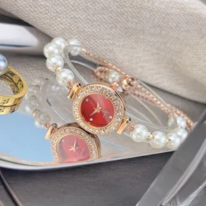Women pearl quartz watch with red dial and rhinestones adjustable bracelet strap detail.