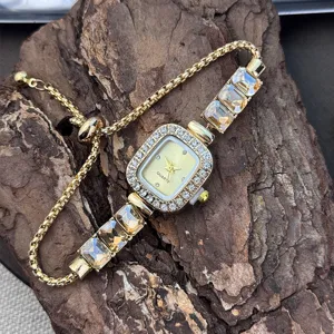 Close-up detail of a glamorous gold women quartz watch with dazzling crystals and pull cord.
