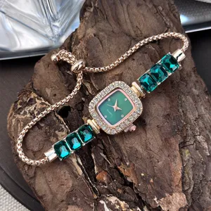 Close-up detail of women square quartz watch with green crystals and adjustable chain strap.