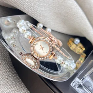 Detail view of the elegant rose gold pearl bracelet watch with sparkling rhinestone bezel dial.