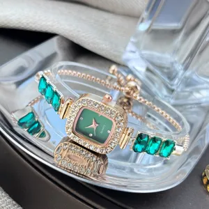 Detail shot of a square green dial rhinestone quartz bracelet watch with adjustable chain.
