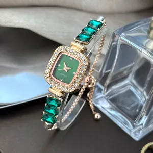 Close-up of a luxury green square quartz watch with dazzling rhinestones and crystals.