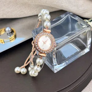Close-up detail of women luxury pearl rhinestone watch with adjustable bracelet design.
