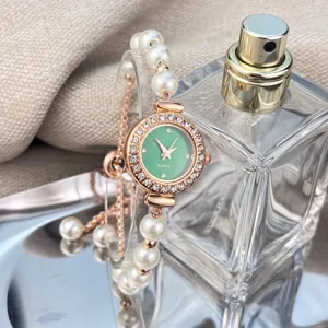 Close-up of women quartz watch with rhinestone bezel, pearl bracelet and adjustable design.