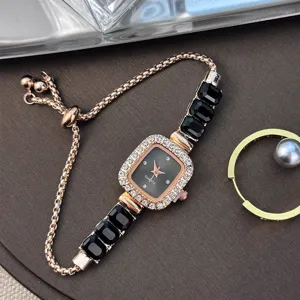 Detail view of women quartz watch, square rhinestone bezel, black crystal link bracelet.