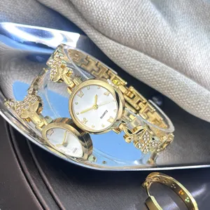 Stilvolle Damenuhr Quarz mit Schmetterling Strass Design, elegante goldene Armband Details.