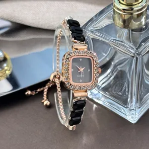Closeup of a square rhinestone quartz watch with black geometric links and adjustable pull strap.