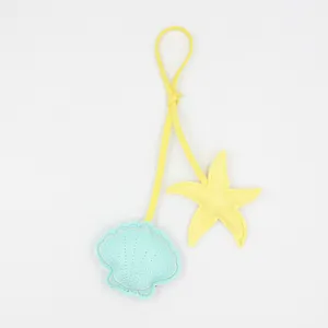Close-up detail of lovely pu leather starfish and shell bag charm pendant in bright color.