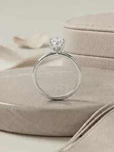 Classic six-prong solitaire ring detail shot, elegant silver band with brilliant round stone.