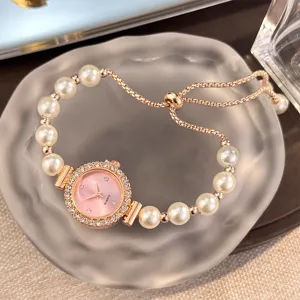 Rose gold pearl quartz watch with crystal bezel and adjustable sliding bracelet design.