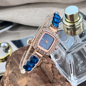Close-up of women quartz watch with square rhinestone bezel and blue crystal bracelet.