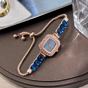 Elegant women quartz watch with blue crystal square dial and adjustable slider chain bracelet.