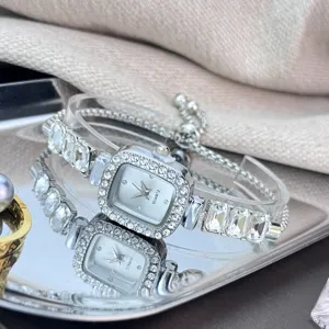 Elegant rhinestone square dial quartz watch with adjustable sliding bracelet strap detail.