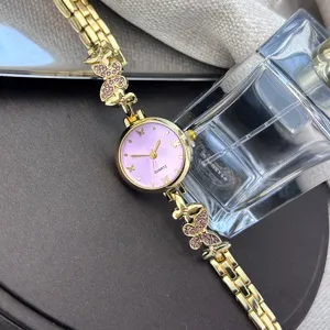 Elegante Damen Quarzuhr in Gold mit rosa Strass Schmetterling Armband und Zifferblatt.