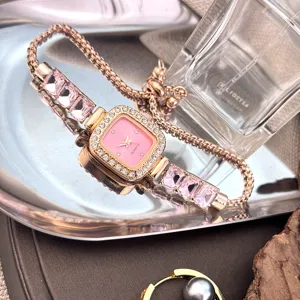 Elegant rose gold quartz bracelet watch with pink square rhinestone dial and crystal strap.