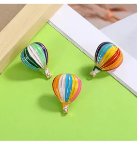 Detailed close-up shot of colorful hot air balloon enameled brooches, alloy decorative pins.